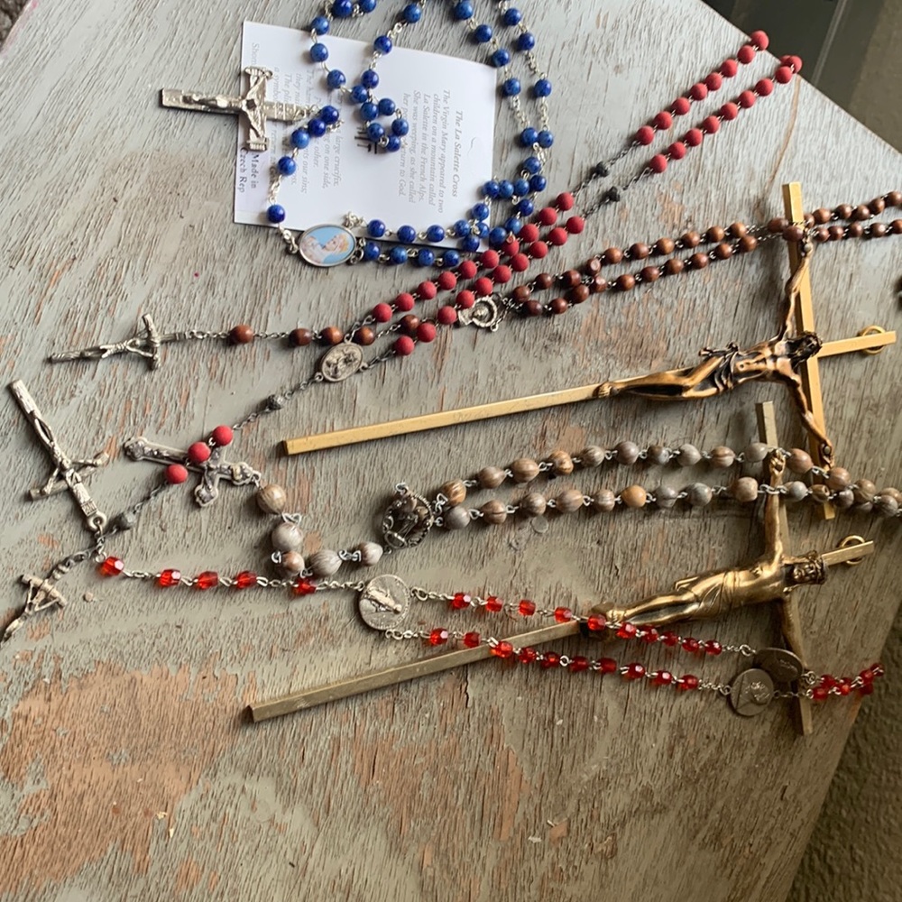 5sets of rosaries and coffin crossed